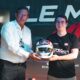 Gérard Neveu presents Rémi Delorme with Buemi's helmet at the Le Mans Virtual Challenge